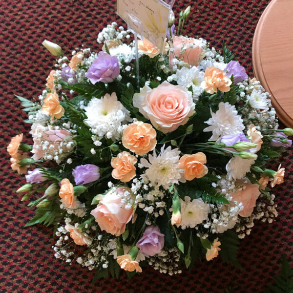 round pastel funeral wreath